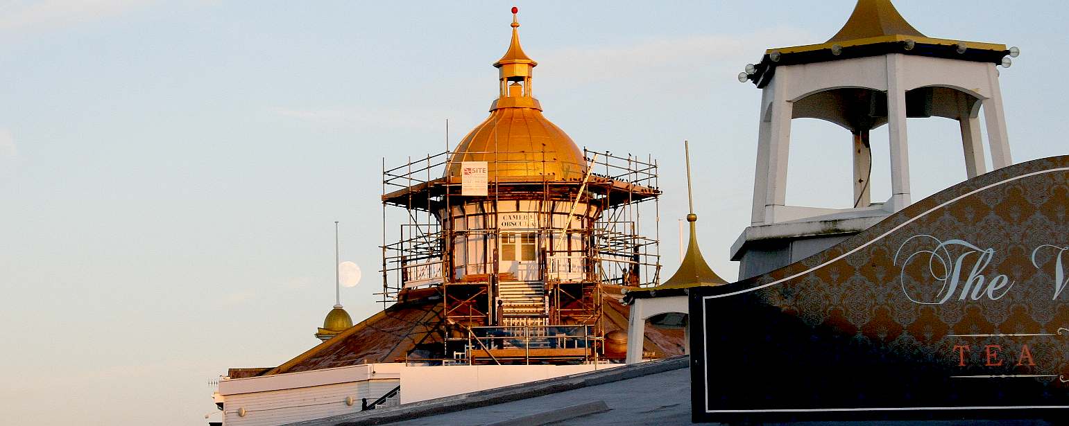 Golden painted camera abscura dome Eastbourne pier