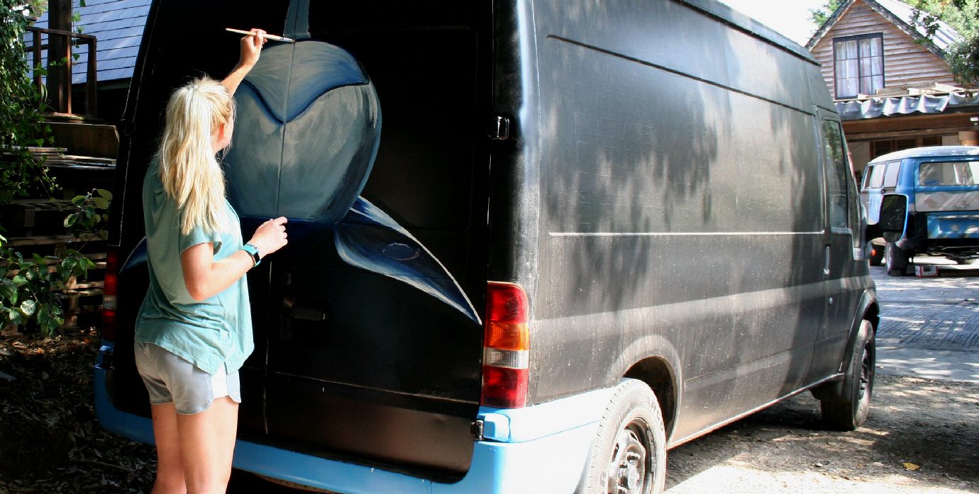 Emily Hoad painting the Ford Transit van