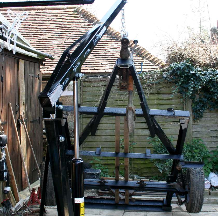 Using a hydraulic engine hoist to lift the trailer high in the air